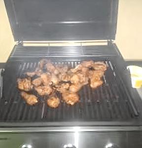 a bunch of donuts are cooking on a grill at Modern Apartment in Grand Baie in Grand Baie