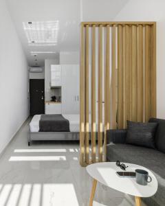 a living room with a couch and a bed at Petalouda in Kallithea Halkidikis +12 photos