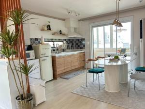 a kitchen and dining room with a table and chairs at Blue Sands in Busan