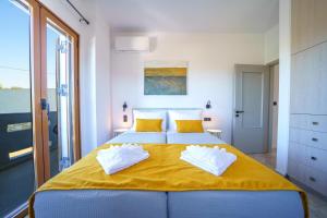 a bedroom with a large yellow bed with yellow pillows at Vera Relaxo Villa, a Countryside Escape in Angeliana +51 photos