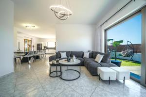 a living room with a couch and a table at Vera Relaxo Villa, a Countryside Escape in Angeliana