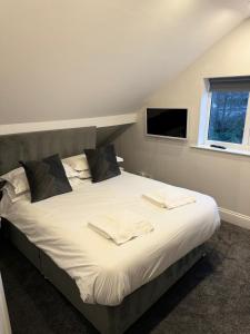 a bedroom with a large bed with towels on it at The PADhouse in York