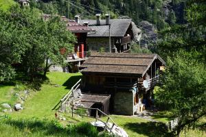 a small house on a hillside with a house at Chalet Il Pruno del Rosa in Macugnaga