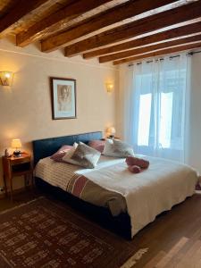 a bedroom with a large bed and a window at Les Romarins in Vallières-les-Grandes
