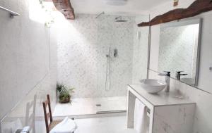 a white bathroom with a sink and a shower at Charming House in Villasur de Herreros with Lake View in Villasur de Herreros