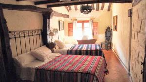 a bedroom with two beds in a room at Charming House in Villasur de Herreros with Lake View in Villasur de Herreros