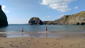a person standing on the beach with their arms up at The Country Haven Aircode V31Y166 in Ballybunion +15 photos