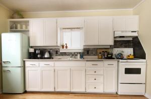 a kitchen with white cabinets and a white refrigerator at Sunrise and Bayview with SNOW SHOES, WATERCRAFTS , BIKES in Meaford