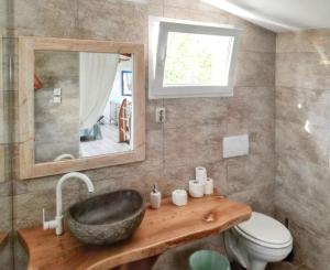 a bathroom with a sink and a toilet and a mirror at Charming Villa in Filozići with Private Pool in Filozići +18 photos