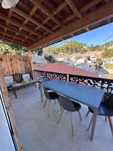 a table and chairs on a patio with a view at Les nuits d'été Niolon in Le Rove