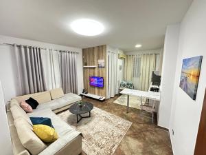 a living room with a couch and a table at Dora apartment in Tirana