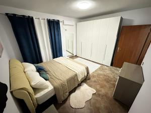 a small bedroom with a bed and a closet at Dora apartment in Tirana