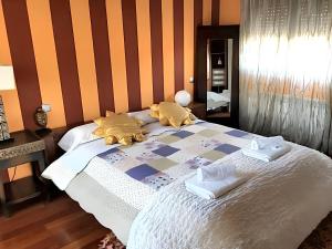 a bedroom with a large bed with orange stripes at Comfortable House in Quintanilla in Quintanilla del Agua