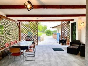 a patio with a table and chairs and a wall at Mountain View PM in Poiana Mărului