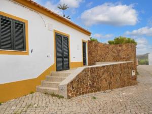 a house with a stone wall and stairs outside at Charming House in Barão de São Miguel in Barão de São Miguel