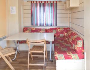 a room with a table and chairs and a couch at Charming Bungalow in Pataias with Shared Pool in Pataias