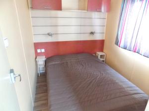 a small bedroom with a bed in a room at Charming Bungalow in Pataias with Shared Pool in Pataias