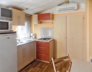 a small kitchen with a sink and a stove at Charming Bungalow in Pataias with Shared Pool in Pataias +16 photos