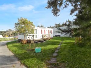 a house in the grass with a yard with a house at Comfortable Bungalow Near Pataias with Shared Pool in Pataias