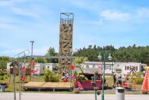 a playground in a park with a slide at Comfortable Bungalow Near Pataias with Shared Pool in Pataias