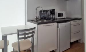 a small kitchen with a sink and a microwave at Charming Bungalow in Pataias with Shared Pool in Pataias