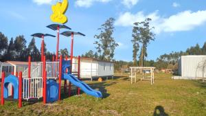 a park with a playground with a slide at Charming Bungalow in Pataias, 18 m² with Shared Pool. in Pataias