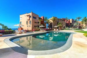 a swimming pool in front of a villa at 2BD Exclusive Cabo Corridor Beach Front Luxury in San José del Cabo