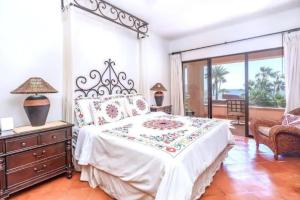 a bedroom with a large bed and a balcony at 2BD Exclusive Cabo Corridor Beach Front Luxury in San José del Cabo +12 photos