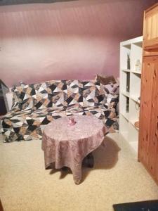 a room with a table and a couch with a table sidx sidx sidx at Cozy Apartment in Estinnes – 40 sqm with a fenced garden. in Estinnes-au-Val