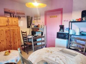 a kitchen with a table and a dining room at Cozy Apartment in Estinnes – 40 sqm with a fenced garden. in Estinnes-au-Val +9 photos