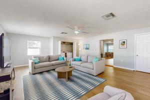 a living room with two couches and a table at My Seaside Escape in Bradenton