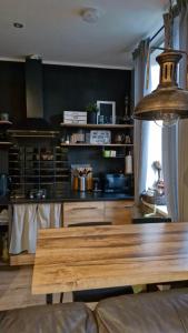 a kitchen with a wooden table in a room at Yu&Yu loft apartment in Rīga +8 photos