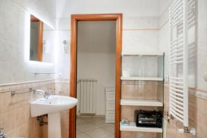 a bathroom with a sink and a toilet and a mirror at Comfortable apartment in Gragnano 45 m² with quiet balcony in Castello +23 photos