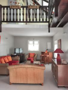 a living room with a couch and a table at Villa de charme à Sainte-Anne avec piscine privée in Sainte-Anne