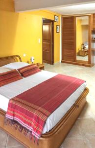 a bedroom with a large bed in a room at Villa de charme à Sainte-Anne avec piscine privée in Sainte-Anne +35 photos