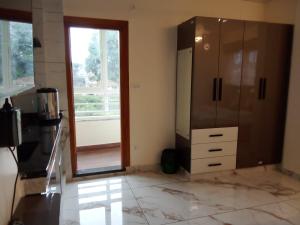 a bathroom with a large cabinet and a mirror at Kamadhenu Residency Homestay & Service Apartment Coorg Madikeri in Madikeri