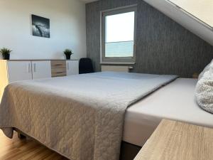 Ένα ή περισσότερα κρεβάτια σε δωμάτιο στο Familienurlaub am Meer