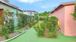 a garden with flowers and a fence at Charmante Maison à Capesterre-Belle-Eau avec Jardin et Terrasse in Capesterre-Belle-Eau
