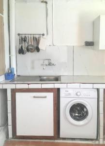 a kitchen with a washing machine and a sink at Maison de charme à Saint-Pierre avec vue sur mer et montagne in Saint-Pierre