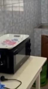 a kitchen with a counter with a machine on a table at 77 Shortlets in Cotonou