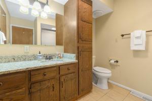 a bathroom with a sink and a toilet and a mirror at Causeway 3026 in Pagosa Springs +17 photos