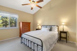 a bedroom with a bed and a ceiling fan at Causeway 3026 in Pagosa Springs