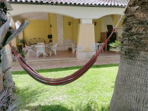 a hammock in the yard of a house at Villa Gabry in Floridia