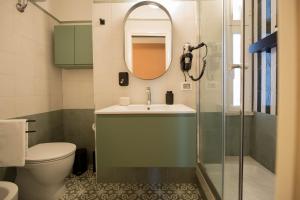 a bathroom with a sink and a toilet and a mirror at Appartamento Sofia in Rome +36 photos