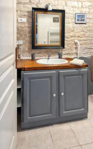 a bathroom with a sink and a mirror at Maison de charme à Sigogne, proche de Cognac, barbecue inclus. in Sigogne +17 photos