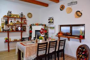 a dining room with a table and chairs at Pensiunea Inima Maramureșului in Breb