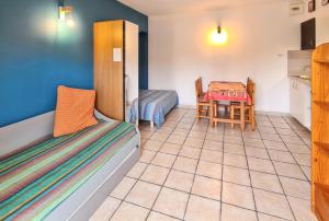 a small room with two beds and a table at Studio confortable à Hyères avec terrasse et jardin – 20 m² in Hyères