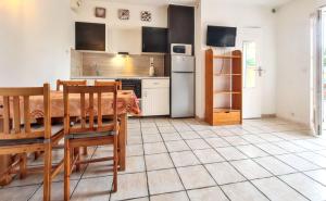 a kitchen with a table and chairs in a room at Studio confortable à Hyères avec terrasse et jardin – 20 m² in Hyères +9 photos