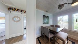 a dining room with a table and chairs and a bedroom at Renovated Lemon Guesthouse 4 KING Bedrooms Downtown Half Mile Stroll- Beach Only 3 Miles in Saint Augustine