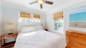 a white bedroom with a bed and a ceiling fan at Renovated Lemon Guesthouse 4 KING Bedrooms Downtown Half Mile Stroll- Beach Only 3 Miles in Saint Augustine